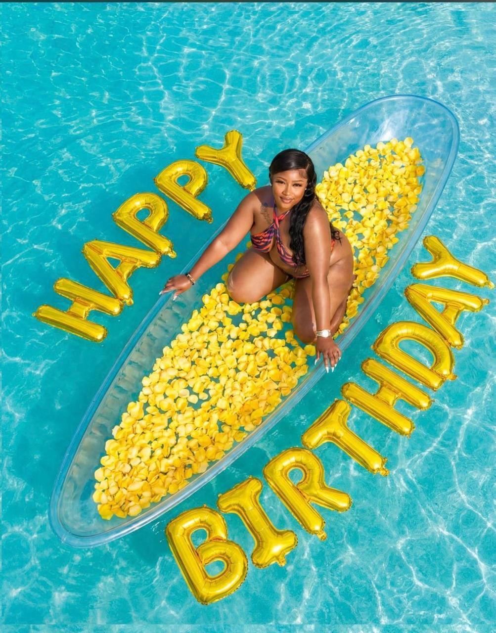 Birthday photoshoot in a clear kayak with gold balloon letters